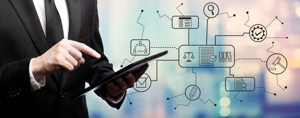 Businessman tapping on a tablet with floating legal icons beside him