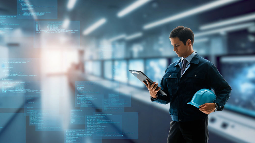 Engineer in factory hallway using digital technology