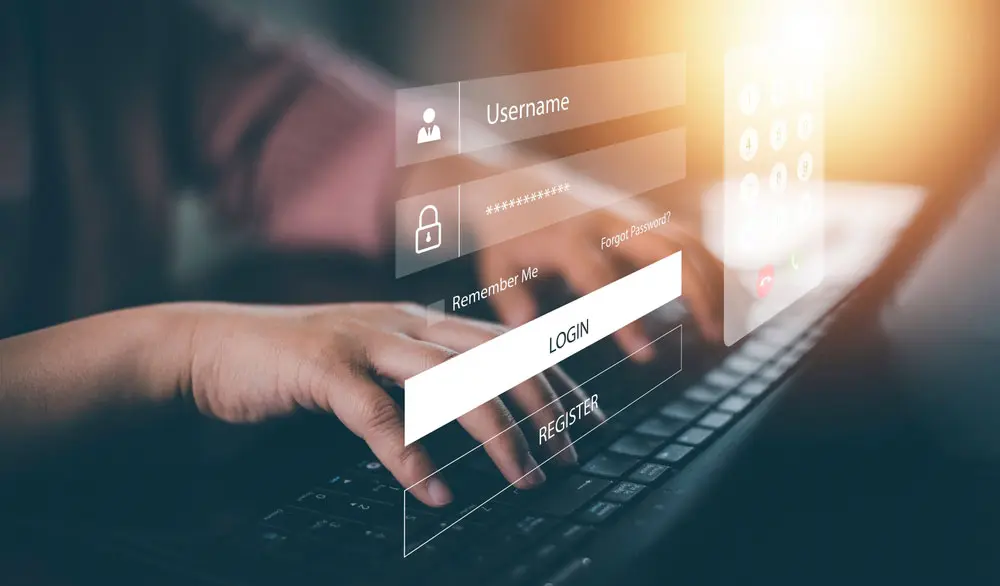 Hands typing on computer keyboard with virtual display for username and password floating above it